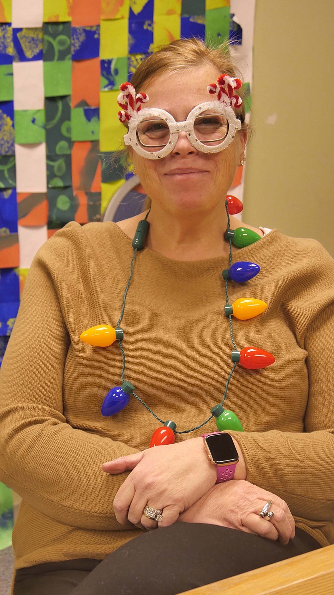 Jamie Borg, principal at Glebe Elementary in Arlington for 18 years, sports her holiday glasses. “I don’t wear the fancy ones until later. I don’t want the kids to go crazy too early.”