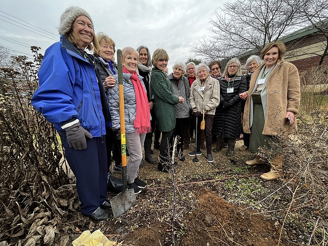 Members of the Great Falls Garden Club and others gather to witness the tree planting.