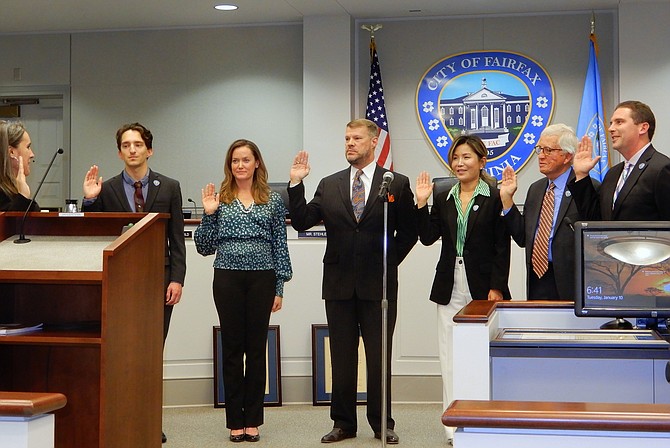 Melanie Zipp swears in (from left) Councilmembers Billy Bates, Kate Doyle Feingold, Jeff Greenfield, So Lim, Tom Ross and Jon Stehle.