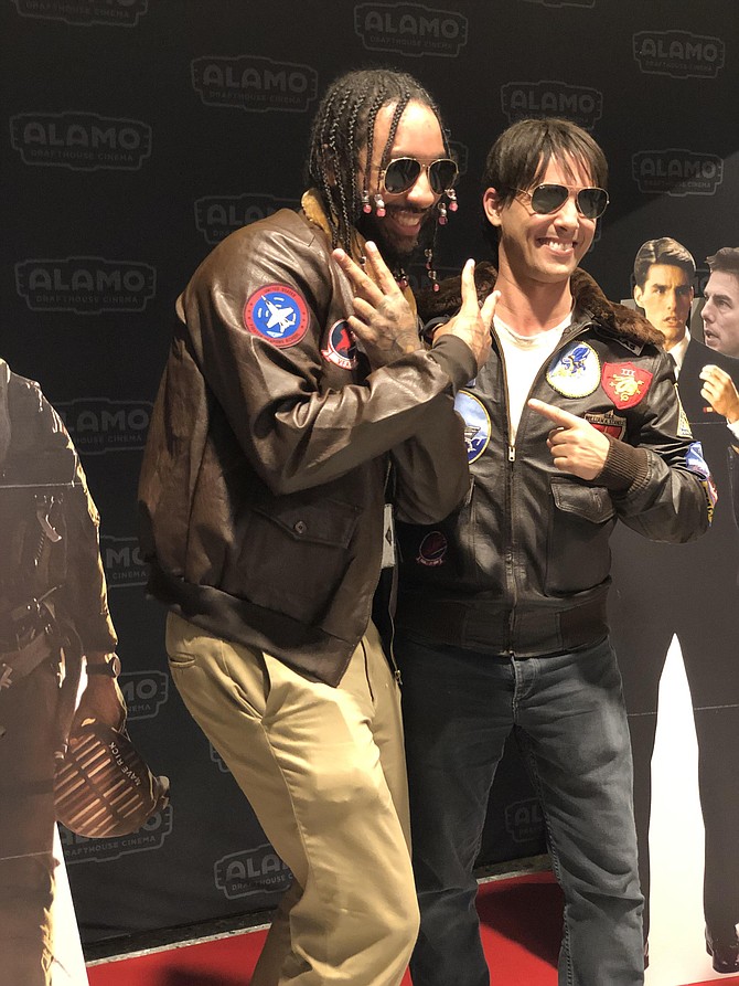 Tom Cruise” posed with invitees to the Alamo Drafthouse Cinema event, here with Geoffrey Moore of PlusUltra Entertainment. PlusUltra is self-described inclusive nerd space for the Black diaspora, collaborating with National Landing BID to put on a showing of Wakanda Forever at the Alamo.