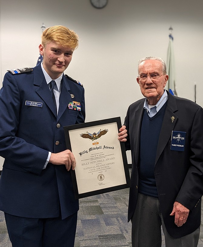 Korean War veteran Colonel Warren Wiedhahn, right, presents Cadet Second Lieutenant Yacov Schwartz with the Mitchell Award for excellence in leadership of the Burke Composite Squadron of the Civil Air Patrol. Photo by Cadet Senior Airman Dennis Choriyev