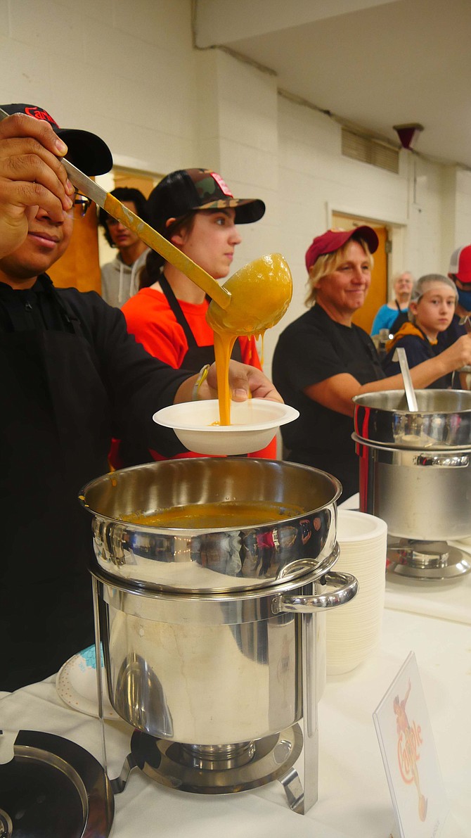 Volunteers ladle out the popular lobster bisque at Empty Bowls Sunday, February 12
