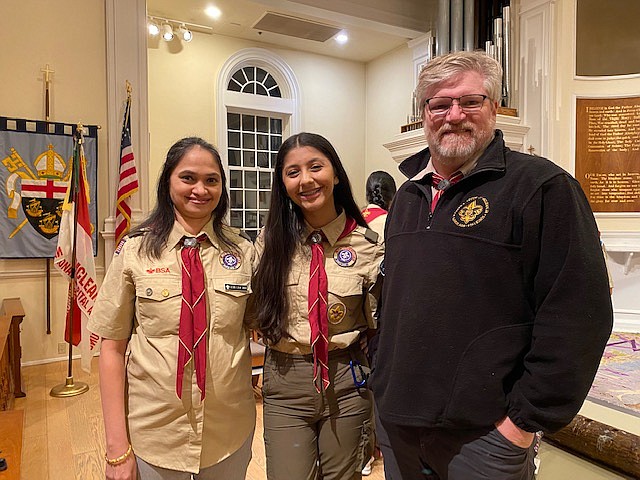 Dia Aurora center, with (from left) her troop, 128 Scout Master, Seena Singh, and BSA assistant scoutmaster, Geoff Balleisen. 

Photo by Kathryn Mackensen