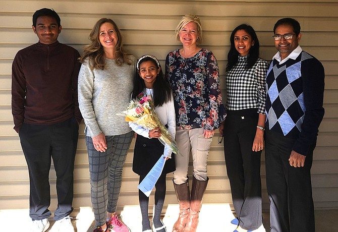 From left: Nayani’s brother, Rishan, Colin Powell Elementary Principal Jamie Luerssen, Nayani, teacher Amy Patterson and Nayani’s parents Pallavi and Raj.