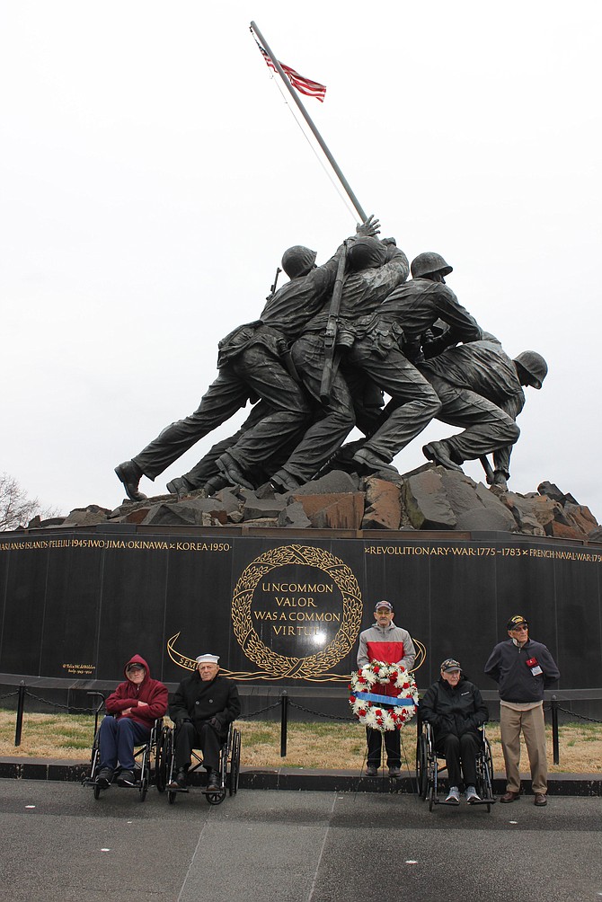 Survivors of the Battle of Iwo Jima pose for a photo following a wreath laying Feb. 17 at the Marine Corps War Memorial to mark the 78th anniversary of the battle. Flanking MGySgt Roger Roll, holding the wreath, are veterans Dale Faughn, Juan Montano, Ivan Hammond and Louis Bourgault.
Photo by Fred Lash