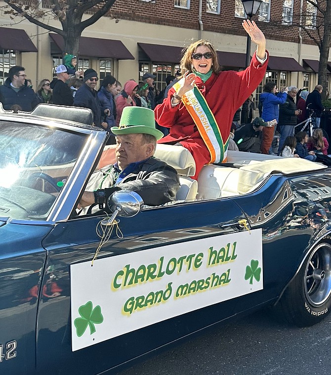 Charlotte Hall, longtime Alexandria business leader, waves to the crowd as the Grand Marshal of the St. Patrick’s Day Parade March 4 in Old Town.