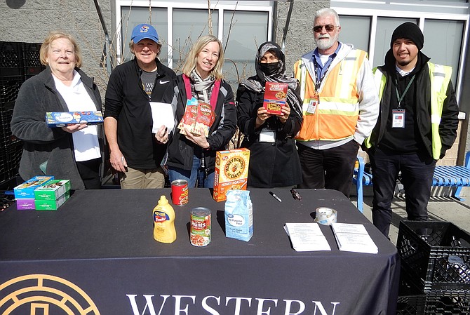 Collecting food donations outside the Chantilly Walmart are (from left) WFCM volunteers Jeanne Kline, Mike Kortan, Katherine Schweit and Shah Sakina, plus Fastran supervisor Ed Boatwright and Fastran driver Camacho Ezequiel.