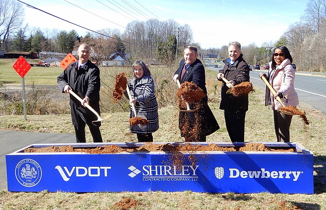 Tossing shovelsful of dirt into the air are (from left) Tom Biesiadny, Kathy Smith, Pat Herrity, Bill Cuttler and Northern Virginia Transportation Authority CEO Monica Backmon.