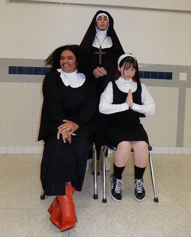 As Mother Superior, Logan Baker (standing) keeps a watchful eye on (from left) Isabella Jackson (Deloris) and Sister Mary Robert (Kaylee Williams).