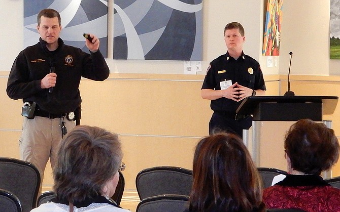 From left, Fairfax City Fire Marshal Bill Murray talks about fire safety at home while fire Lt. David Arrington and attendees listen.