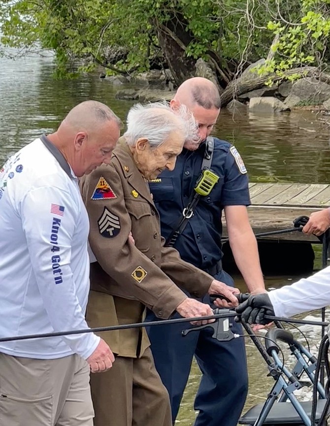 Helping hands extended in thanks for military service at the core of Veteran Fishing Adventure; Ed Moore with World War II Veteran Val Dadamio, 100.