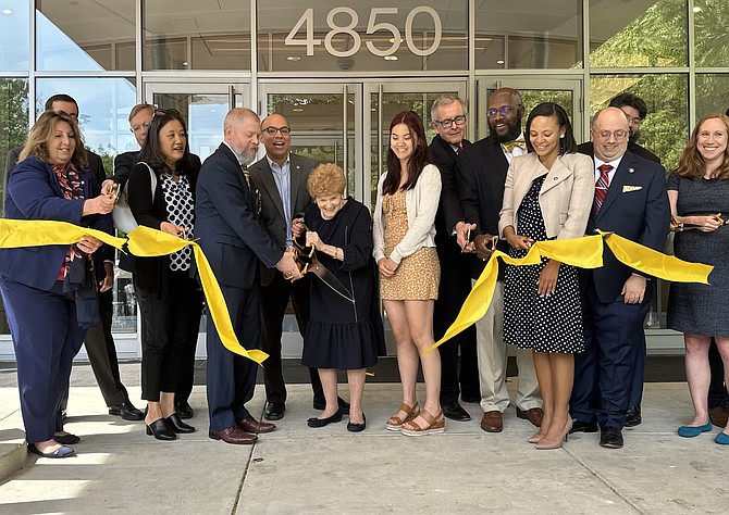 Former City Councilwoman Del Pepper, center, is joined by family and local officials as she cuts the ribbon for the new Redella S. “Del” Pepper Community Resource Center April 27 at 4850 Mark Center Drive.