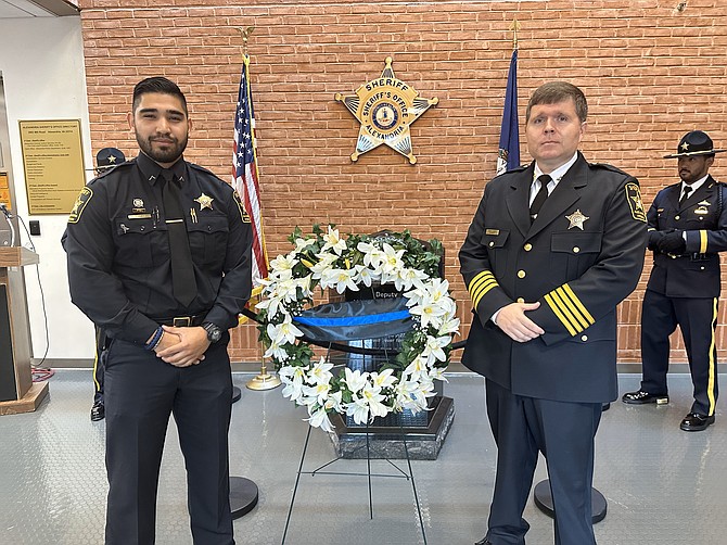 Deputy Sheriff II Carlos Cañas, left, and Sheriff Sean Casey stand after placing a wreath at the William G. Truesdale Memorial May 3 at the headquarters of the Alexandria Sheriff’s Office.