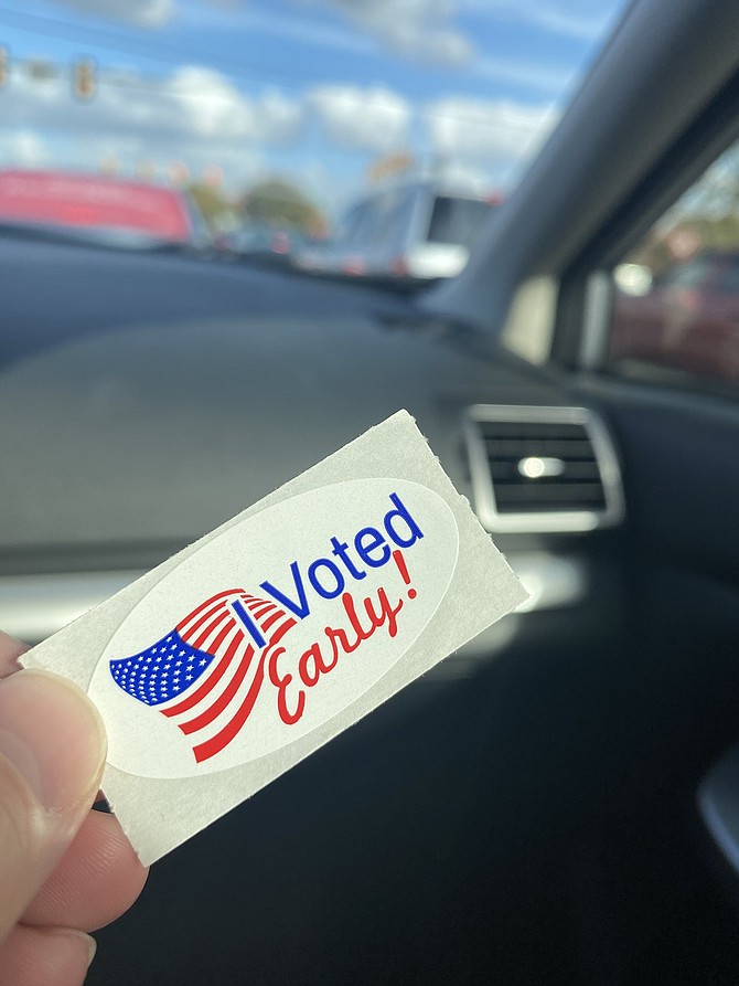 A voter shows their early voting sticker. Over 1 million absentee ballots have been requested in Virginia  this year.