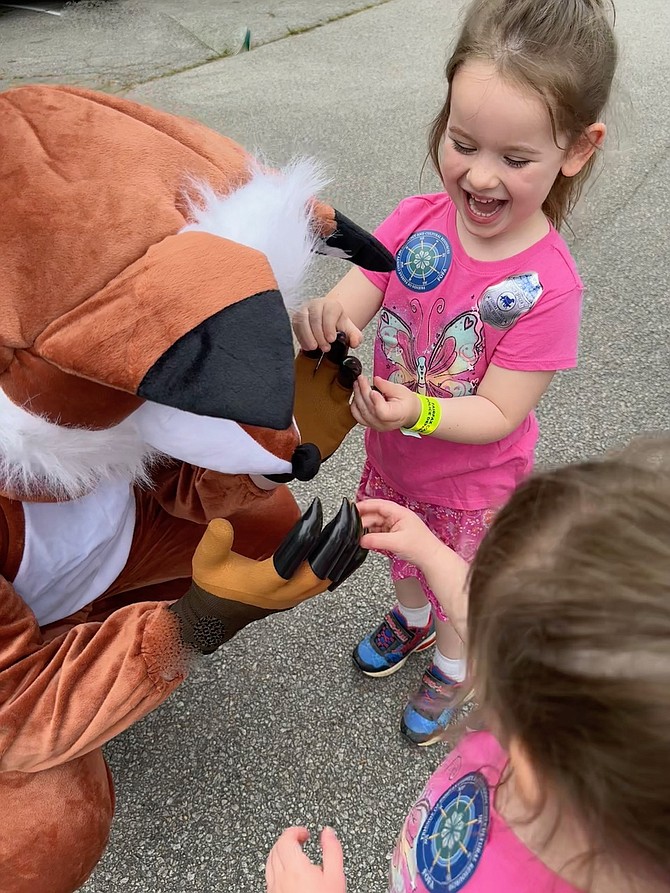 Cat Young, 4 yrs old, and her sister Eve, 3 yrs old, check the claws of a larger than life Red Fox at the Friends of Mason Neck State Park annual Eagle Festival on Saturday, May 13.