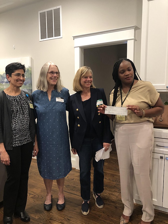 From left, Surekha Cohen, R.N., Director of Clinical Services, Arlington Free Clinic; stands with Candy Fowler, a past president of Arlington Women's Civic Alliance; Donna Alpi, Chairman of the Board of Directors of the Arlington Free Clinic; and Diana Namugenyi, Director Finance, AFC, as the check was handed to AFC.