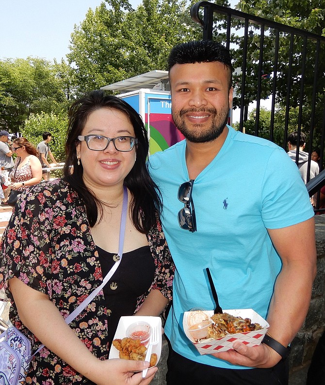 Annie Chan and Tony Tran holding fried oysters and oyster pancakes.