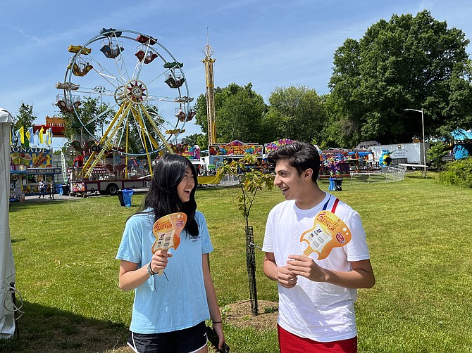 Ava Zhang, 13, of McLean, and Ray Zand, 13, of McLean, are ready to hit the rides at the McLean Day 2023 festival.