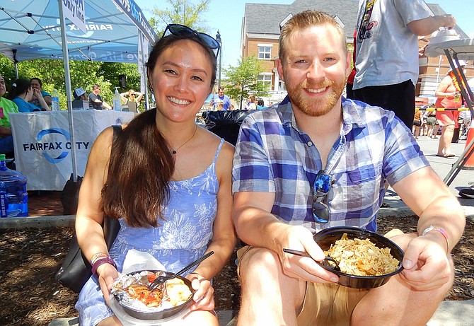 Kathleen McGurk and Patrick Smith enjoying chicken dishes at last year’s Beer in the ’Burbs.