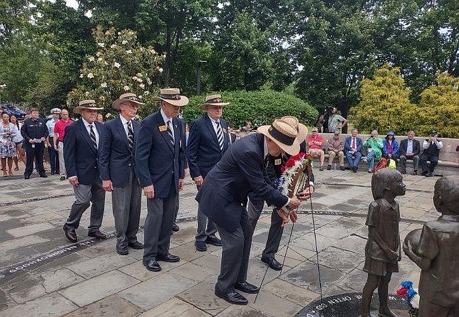 Members of the West Point Class of 1959 and classmates of Humbert “Rocky” Versace prepare to place a wreath at the Captain Rocky Versace Plaza and Vietnam Veterans Memorial May 29 in Del Ray.