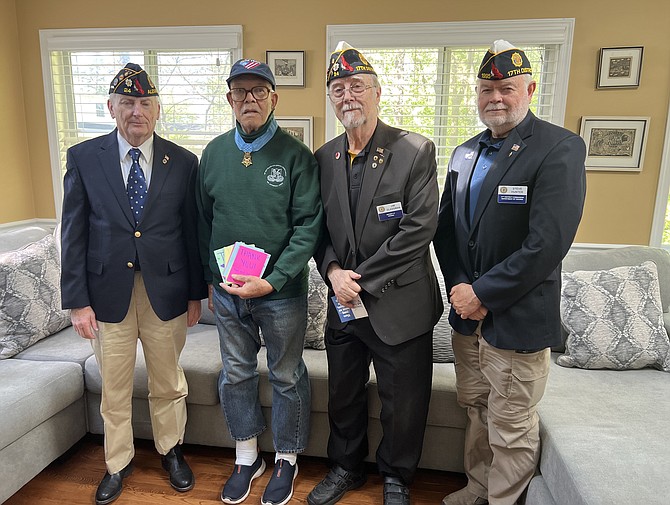 Col Paris Davis (ret), second from left, holds a collection of cards from an elementary school in N.J. congratulating him on receiving the Medal of Honor from President Joe Biden. The cards were presented to Davis April 18 by American Legion Post 24 representatives Henry Dorton and Jim Glassman and Virginia 17th District Commander Steve Hunter.