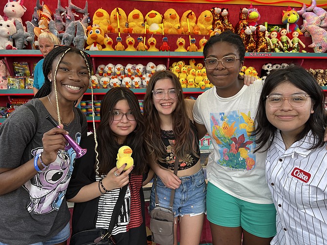 From left, Chloe Whyte, 14, of Reston, Kaylie Serafin, 11, of Herndon, Kass Harmon, 13, of Herndon, Carly Hicks, 14, of Reston, and Valerie Serafin, 14, of Herndon, are ready for the carnival rides. "I'm looking for some screaming rides," Carly says. "Because I like to scream."