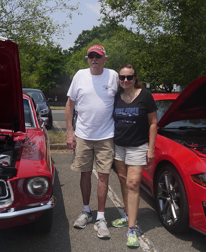 Bob and Debbie Strauss stand between their 1968 Ford GT Mustang and their 2018 50-year anniversary GT Mustang.