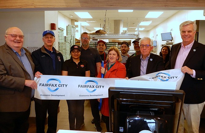 Cutting the ribbon on Marco’s Pizza are (from left) Doug Church, Tom Scibilia, Sonia Sabharwal, Catherine Read, Tom Ross and City Revenue Commissioner Page Johnson.