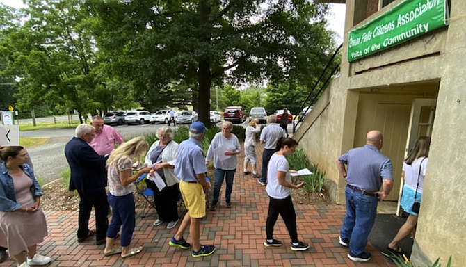 GFCA voters check information as they walk into the Great Falls Grange.