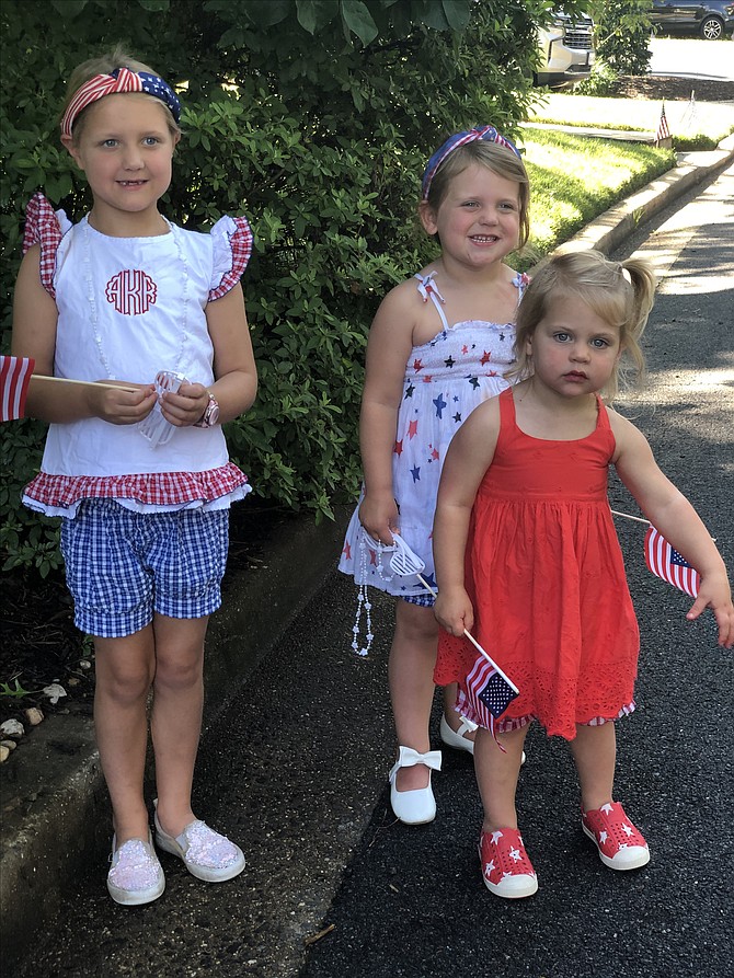 Three sisters,  Vivien, Avery, and Emily, from right, ages 2, 4 and 6 enjoying the parade vibe.