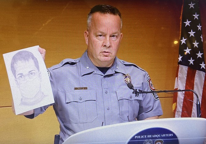 During the press conference, Police Chief Kevin Davis shows the sketch of the suspect.