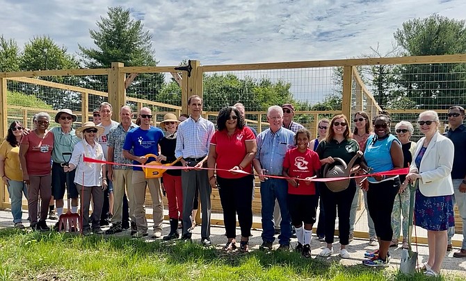 Supervisor Dan Storck (center), Park Authority executive director Jai Cole, and Park Authority board member Linwood Gorham, join county project staff and gardeners to officially open the Laurel Hill Community Gardens