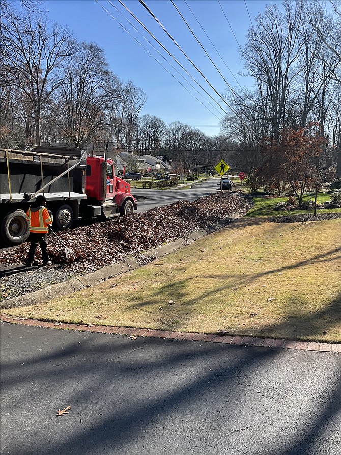 Vac crew removes leaves raked to curb in Fairfax County.