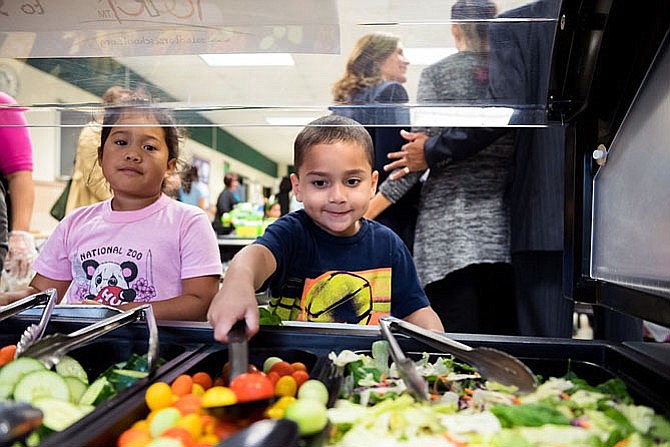 Children at Fairfax County Public Schools dig into a salad bar.
(File photo courtesy of Fairfax County Public Schools)