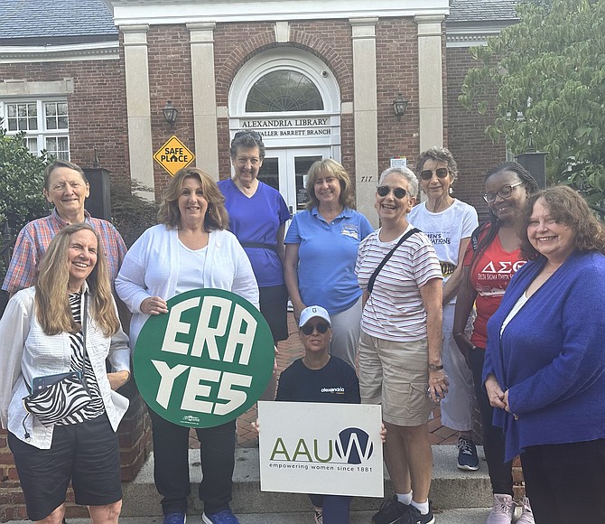 Photo by Janet Barnett/Gazette PacketALEXANDRIA CELEBRATES WOMEN – Gayle Converse, kneeling center, poses for a photo with supporters prior to starting a 133-mile walk to Richmond to bring awareness to women’s rights. Converse began her walk at the Kate Waller Barrett Branch library with plans to arrive at the Virginia Women’s Memorial in Richmond by Aug. 26 – Women’s Equality Day.  www.alexandriacelebrateswomen.com