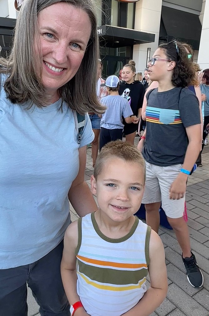 Eli Mechiche, 6 years old, of Ashburn, attending the grand opening ribbon cutting event at the Discovery Center with his mother and sister, who is a LEGO mini-builder, says, “I like LEGOs.”