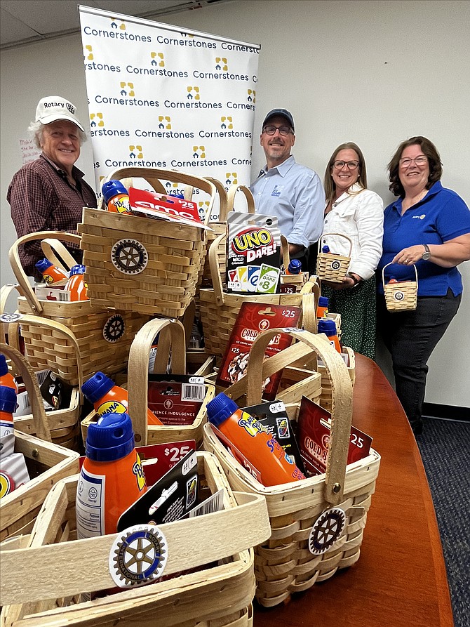 Great Falls Rotary Club members (left to right) Bob Dinkel, Steve Flannery, and (far right) Connie Sawtell, president-elect, join Meredith Hovan, vice president of resource development at Cornerstones, as she accepts their donation of 40  ‘End of the Year’ baskets. The donation is on behalf of the club and supports its community service activities.