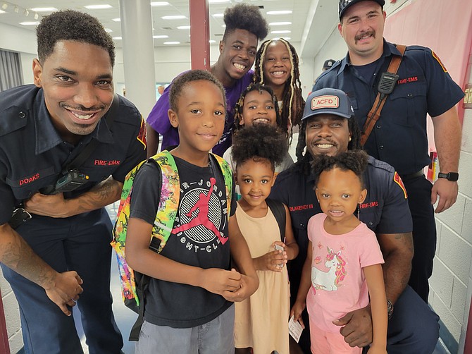 Arlington County Firefighters filled backpacks for Drew Elementary school children and presented them at the Green Valley Back to School Rally on Saturday, Aug. 26.
