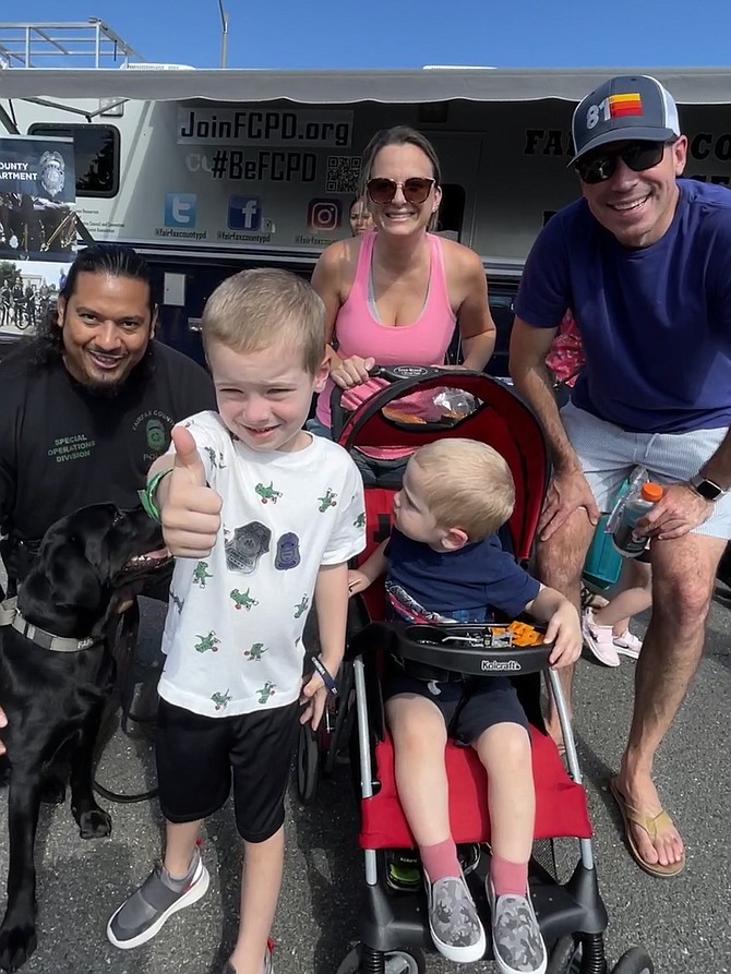 Detective Ramirez, special operations, Fairfax County Police Department, and his K9 partner visit with the Murphy family of Clifton, Brom, 5, Joy, 2, and their parents, Lincoln and Michael.