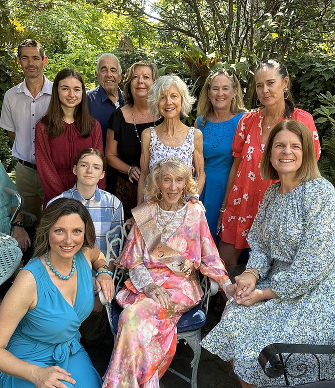 Eve Capps, seated center, turned 100 years old on July 31. She celebrated with friends and neighbors at the Old Town home she has lived in for 70 years.