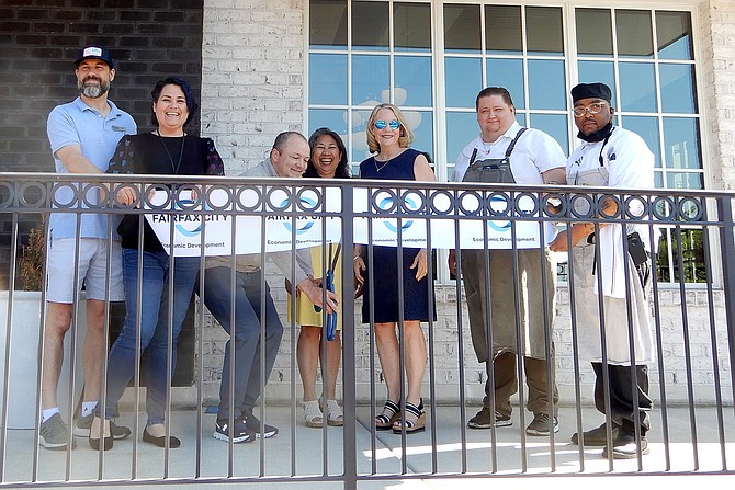 Cutting the ribbon are (from left) Josh Alexander, Tara Borwey, Aaron McDade, Tess Rollins, Dawn McGruder, Chef Stephen McRae and sous chef Chuck Taylor.