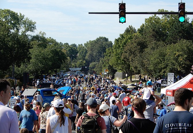 Some of the many attendees of the Labor Day Car Show make their way down University Drive.