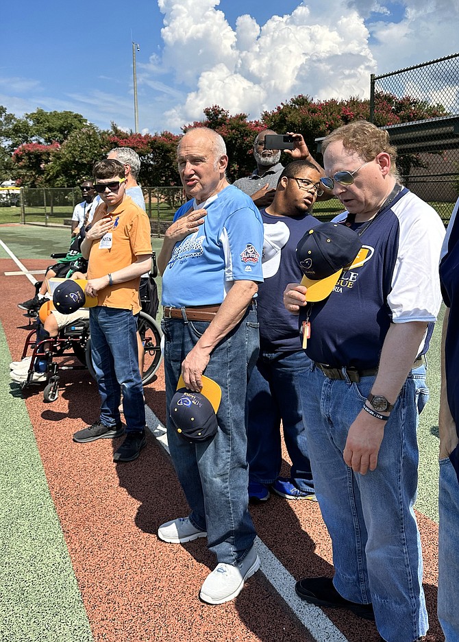 Miracle League teammates place their hands over their hearts during the National Anthem Sept. 9 at the Nannie J. Lee Recreation Center Miracle Field.