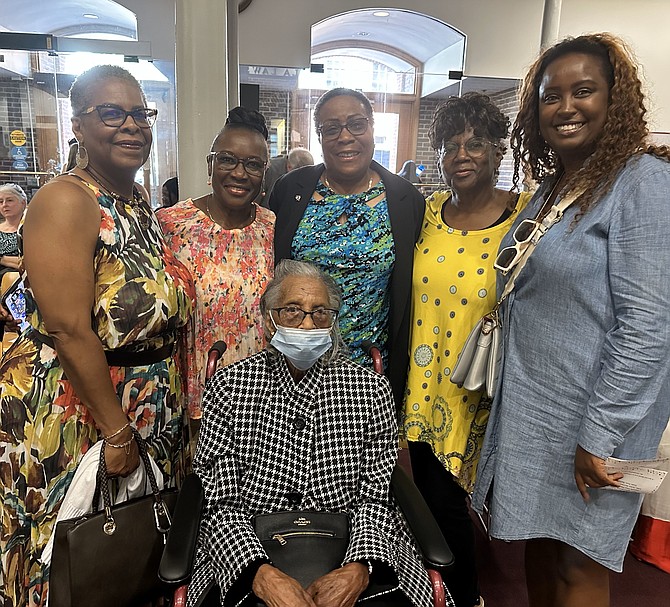 Family members and friends gather around Ann Samuel, seated, as the 103-year-old is honored at the Centenarian Celebration Sept. 12 at City Hall.