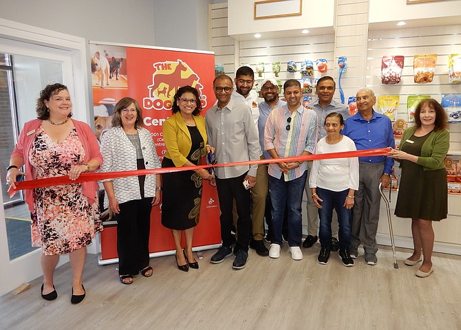 Cutting the ribbon: from left, Jennifer Rose and Kathy Smith, plus Hiral, Bhavesh and Sahil Mehta and others in attendance.