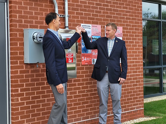 Chairman Jeff McKay and Supervisor Dan Storck flip the switch to turn on the solar panels.