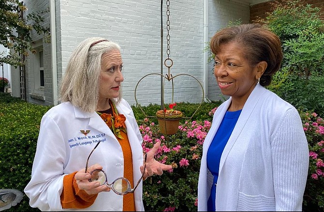 Speech language pathologist Susan I. Wranik, left, talks with Deborah Tompkins Johnson on communicating effectively with dementia patients.