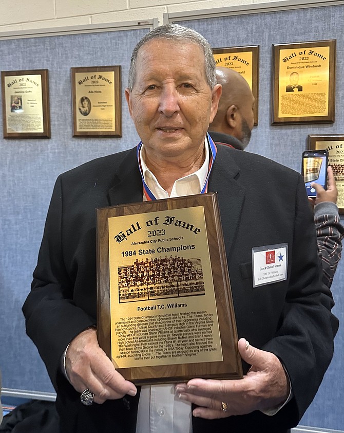 Glenn Furman, former T.C. head football coach, holds his plaque as a 2023 inductee into the ACPS Athletic Hall of Fame Oct. 14 at Alexandria City High School.