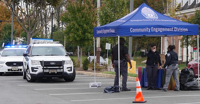 The ACPD Community Outreach Division tent is set up in a corner of the Harrison Teeter parking lot on Friday, Oct. 20 to accept essentials and cold weather donations for Arlington’s unsheltered.