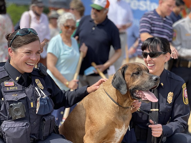 The photo of Officers Pitts and Prucnal, with Wallace, captures the joy of the moment of celebration with the community.